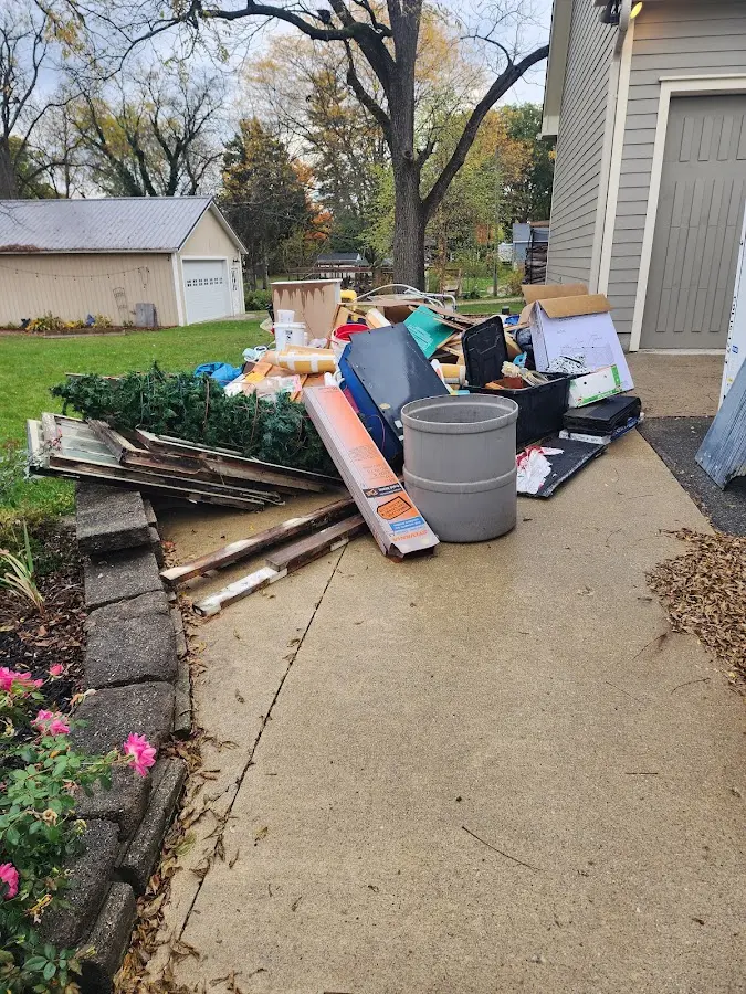 Dumpster being loaded with debris for Roofing Dumpster Rental in Mission Hills